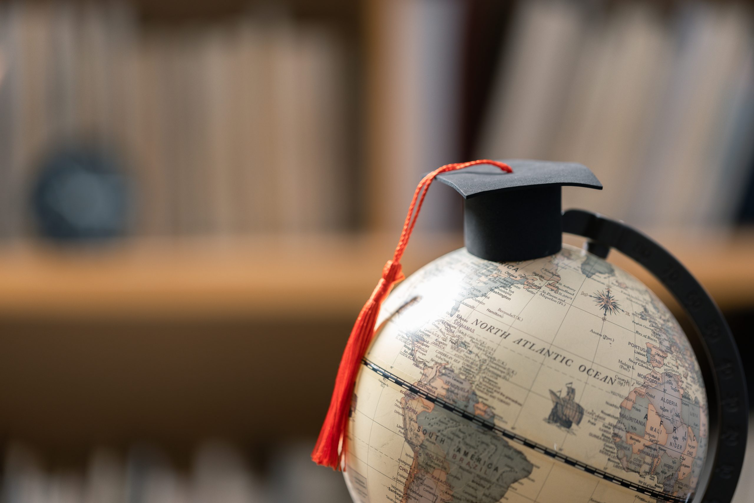 Graduation cap with Earth globe. Concept of global business study, abroad educational, Back to School. Education in Global world, Study abroad business in universities in worldwide. language study